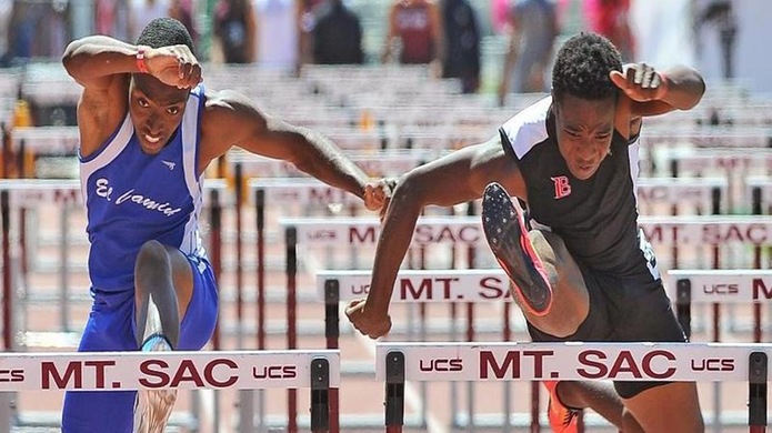 Freshman Bayron Manuel (right) edged Chris Graham (left) of El Camino for first place in the 110-meter high hurdles at the Mt. SAC Invitational Relays (Photo by Dean Lofgren)